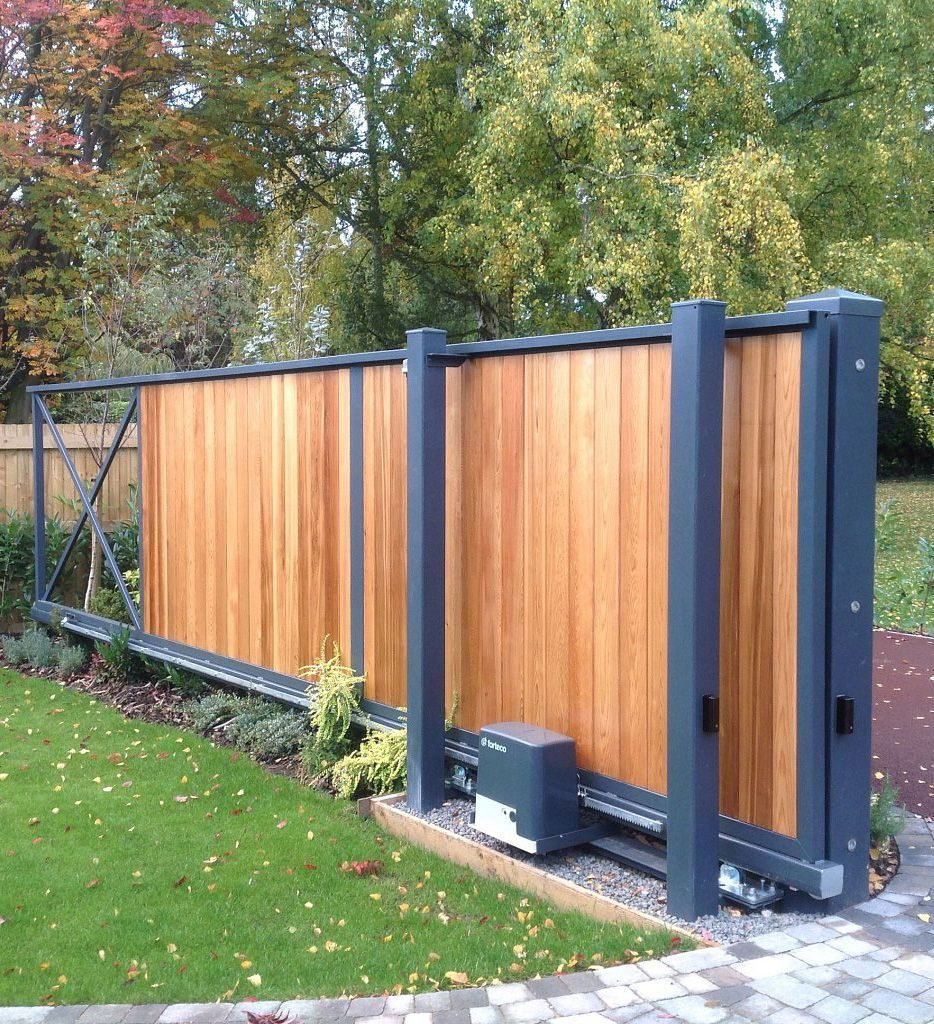 Timber-clad sliding gates like these for homes in Belfast